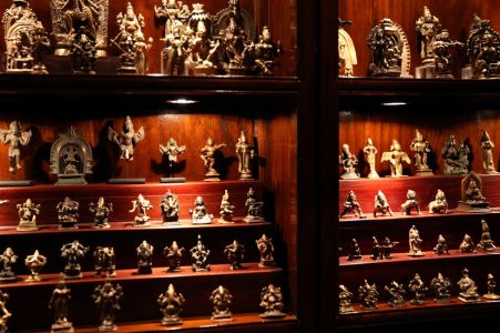 A collection of 9th – 19th C. Indian Pilgrimage Bronzes displayed on custom made stepped bookcase inserts illustrates the importance of furniture in collection display; PRIMITIVE 4th Floor; December 2016