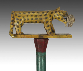 Linguist staff depicting a leopard holding a porcupine