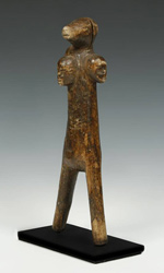 Baule slingshot depicting a boars head surrounded by multiple faces
