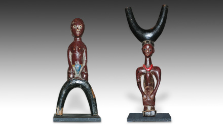 Two carved and painted Baule slingshots depicting a male and female