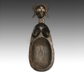 Highly stylized wunkirmian spoon, or ladle depicting a female form with breasts