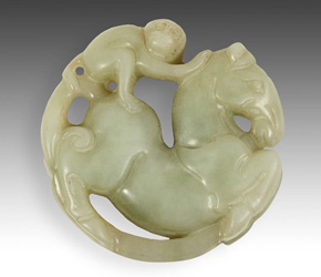 Jade toggle depicting a monkey riding a horse