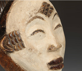 Mukudj masks by the Punu people depict white faces, thin slit eyes, and distinctive scarification marks
