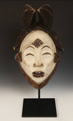 Mukudj masks by the Punu people depict white faces, thin slit eyes, and distinctive scarification marks