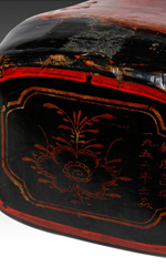 A Chinese lacquerware pillow with decorative floral motifs  on each end