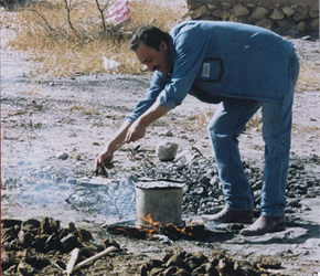 An artist using a kiln-less pottery firing method at Mata Ortiz