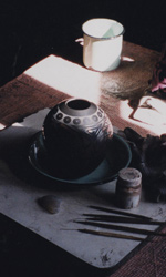 Fired pots are then hand painted inside the artist's home and small studio spaces