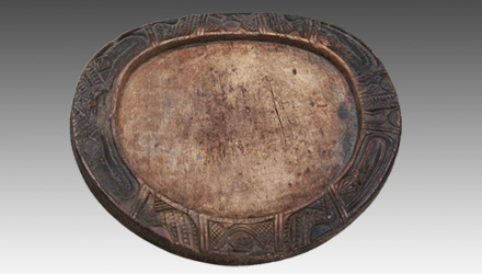 The edges of an Opon Ifa divination boards have various raised carvings depicting humans, animals and geometric designs