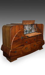 This bar cabinet has a walnut veneer with brass mounts This bar cabinet has a walnut veneer with brass mounts