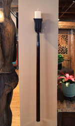 The iron barrel is mounted atop a wooden handle The iron barrel is mounted atop a wooden handle