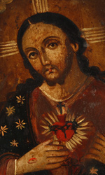 The blazing sacred heart is shown wounded and encircled by a crown of thorns; above it a crucifix