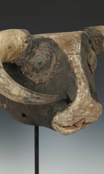 Green glass is used to embellish the eyes of Dugn'be masks Green glass is used to embellish the eyes of Dugn'be masks