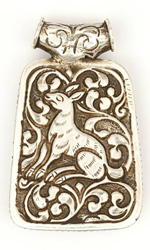 The back of this pendant reveals a deer motif incised in silver