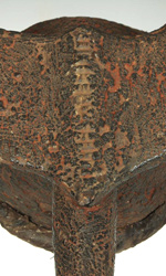 This mangam mask features a stylized mouth and horns and the unmistakable patina of use
