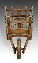 Constructed in elmwood, this Wheelbarrow is atypical in appearance and function