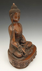 Bhaisajyaguru holds a vessel containing the elixir of life in one hand and a medicinal plant called Myrobalan in the other