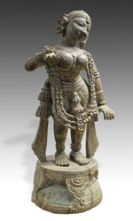 Carved in teak wood, this figure of Radha stands on a lotus base and is nearly 6 feet tall