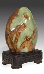 This jade Gongshi is presented on a fitted hand-carved hardwood base