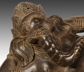 Carved riverstone reclining figure of Ganesh
