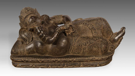 Carved riverstone reclining figure of Ganesh