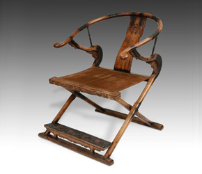 A folding throne horseshoe backed arm chair