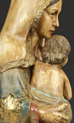 The Madonna is accentuated by her richly carved and musically flowing robe