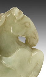 Jade toggle depicting a monkey riding a horse